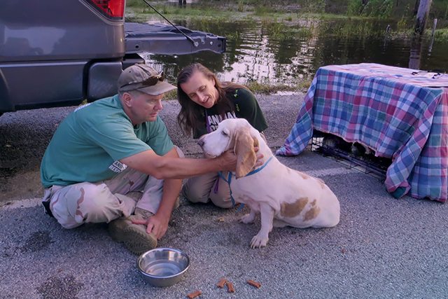 Kinship Circle Field Response Managers Ron Presley and Cheri Deatsch sit with a dog rescued after Hurricane Harvey in Vidor, TX. (c) Kinship Circle, Hurcn Harvey