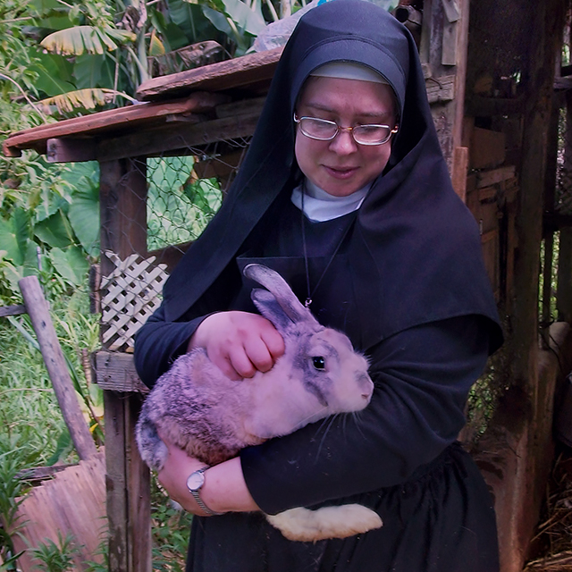 Sister Michael Marie comforts a scared bunny left behind when most residents fled Santa Rita, a community leveled beneath a mass mudslide. (c) Kinship Circle, Brazil Mudslides