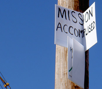 A sign says Mission Accomplished on a pole by the Lakeview levee breach, in bitter sarcasm toward Katrina flood ruins yet to be rebuilt 350x306