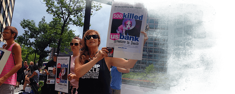Brenda Shoss and Alex Graff protest US Bank's bailout loan to criminal animal testing lab, Huntingdon Life Sciences. (c) Kinship Circle