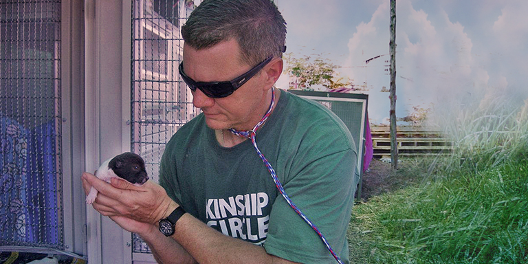 Ron Presley hold newborn puppy of floods, Kinship Circle