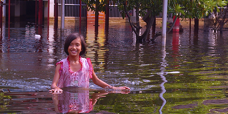 A girl in deep water helps us board boat, Kinship Circle