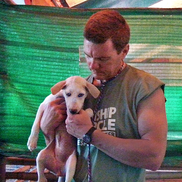 Ron Presley with rescued pup (c) Kinship Circle