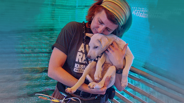 June Towler comforts rescued dog (c) Kinship Circle